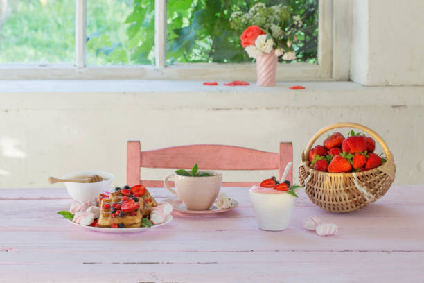 breakfast with strawberries on pink wooden table