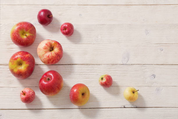 istock apples on wooden white background 1093896438