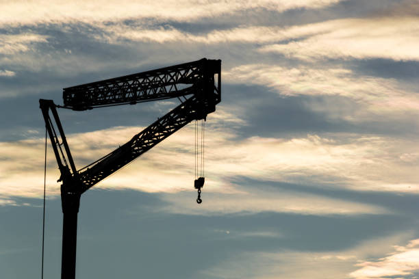 istock Silhouette tower crane against blue sky 1093896592