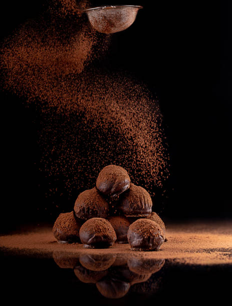 chocolate truffle chocolate truffle on a black background chocolate truffle stock pictures, royalty-free photos & images