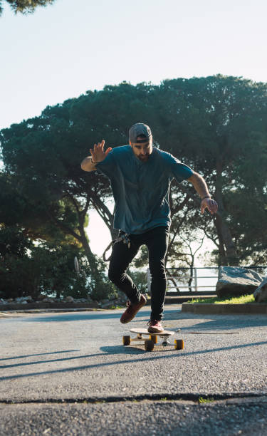 istock Man practicing with his long board on a lonely street in a sunset 1093901110