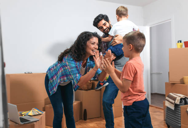 istock Happy young family having fun while moving into their new home. 1093901184