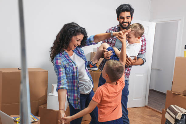 istock Happy young family having fun while moving into their new home. 1093901784