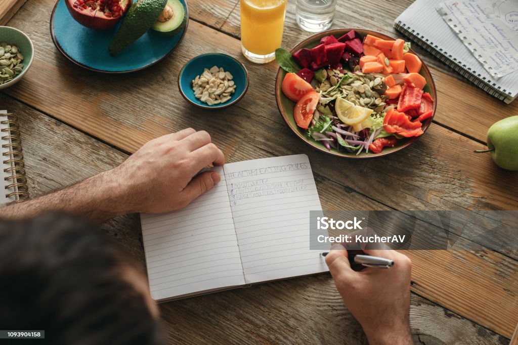 Healthy lifestyle diet food Man healthy food Man makes a list of healthy food. Healthy lifestyle diet food concept Planning Stock Photo