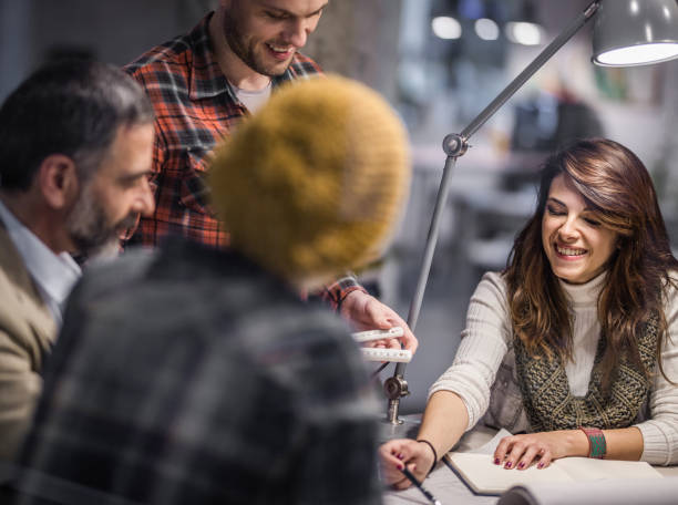 istock Happy female architect cooperating with her colleagues on a meeting. 1093904184