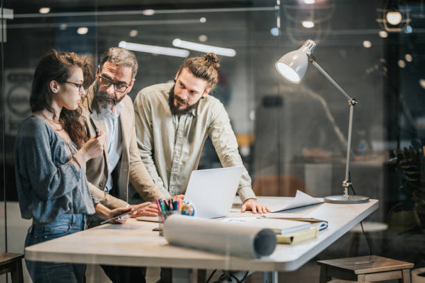 istock Team of architects discussing while working on new project in the office. 1093904300