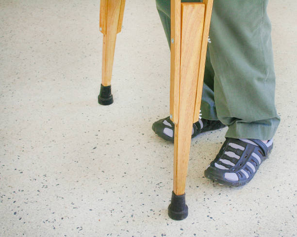 istock Man using wood crutches on terrazzo floor background 1093907648