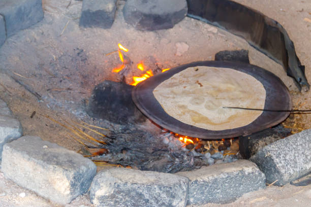 istock Traditional arabic pita bread cooking on fire in bedouin dwelling 1093909018