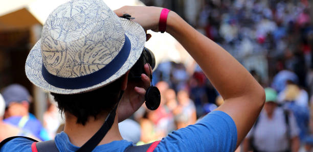 istock boy with a hat photographs tourists walking 1093909110