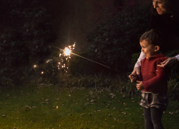 Boys holding spraklers for New Year's Eve