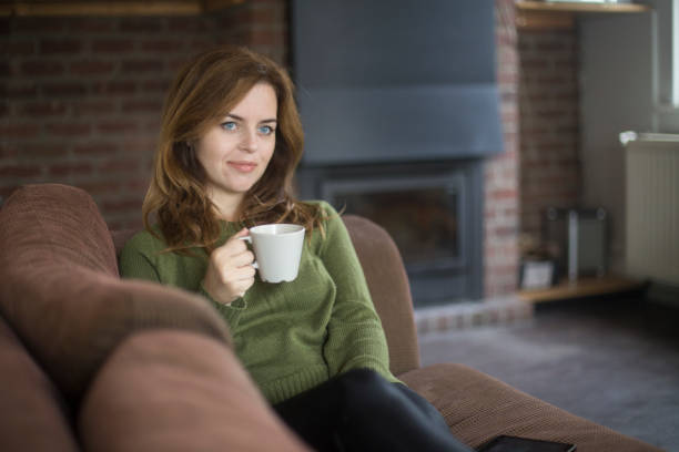 istock Woman drinking hot tea at home 1093909480