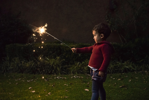 Boys holding spraklers for New Year's Eve