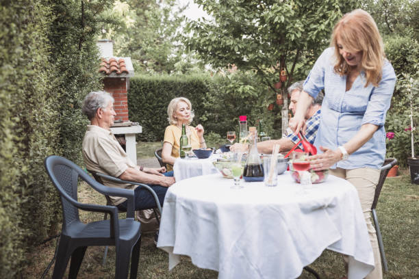 istock Senior people, friends, enjoying backyard barbecue 1093914574