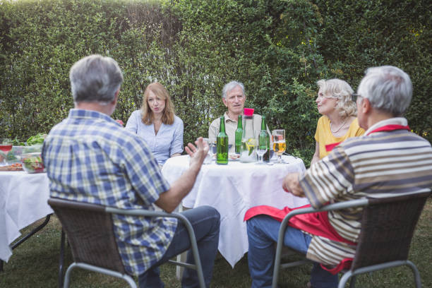 istock Senior people, friends, enjoying backyard barbecue 1093914640