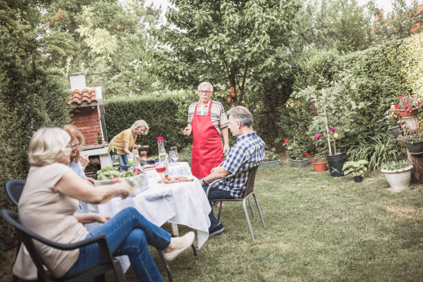 istock Senior people, friends, enjoying backyard barbecue 1093914748