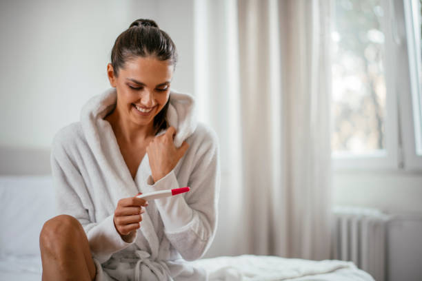 istock Woman looking at home pregnancy test 1093915104