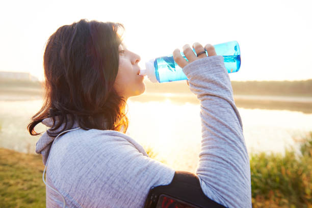 istock Woman drinking water after really hard workout 1093915466