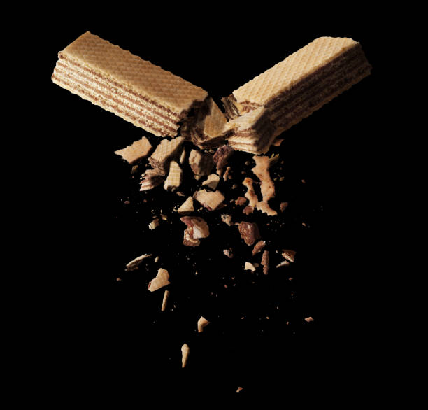 The clash of two waffles on a black background
