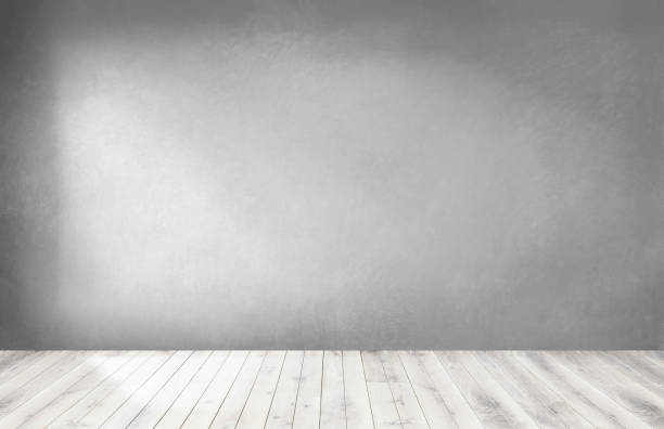 istock Gray wall in an empty room with a wooden floor 1093917408