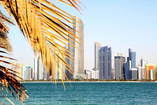 istock Abu Dhabi Skyline with water and palmtree 1093921794