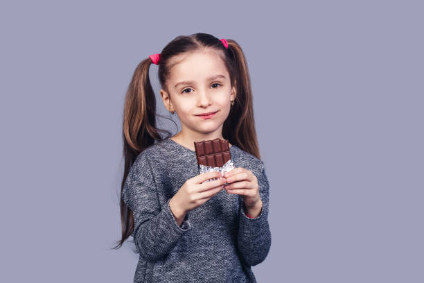 istock Little joyful girl holds chocolate in hands. 1093922344