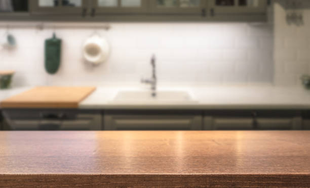 istock Wooden table top on kitchen island in front of blurred home interior. 1093922356