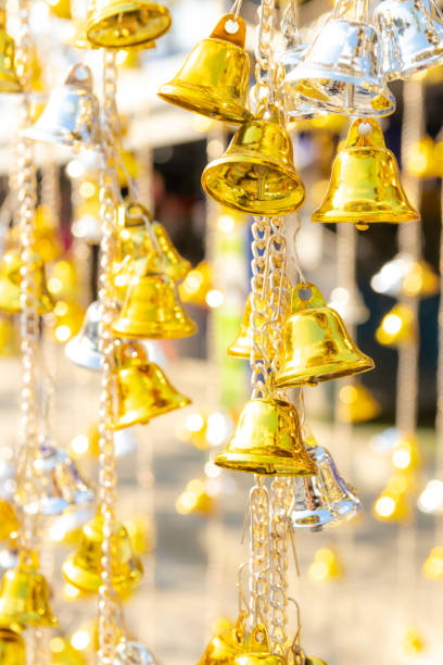 istock small golden bells hanging with bokeh background 1093922850