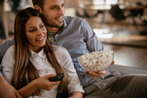 istock Young couple with popcorn looking movie 1093925292