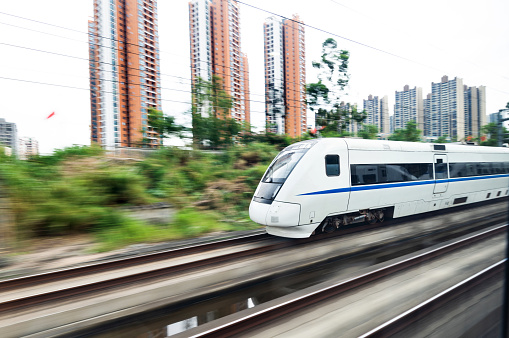 High speed train driving in the city.