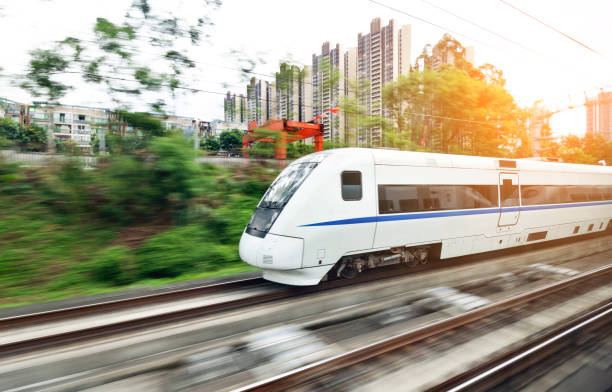 High speed train driving in the city High speed train driving in the city. commuter train photos stock pictures, royalty-free photos & images