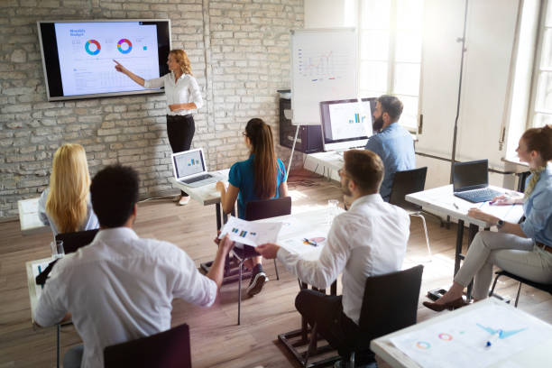 istock Successful happy group of people learning software engineering and business during presentation 1093925776