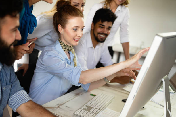 istock Successful happy group of people learning software engineering and business during presentation 1093925804