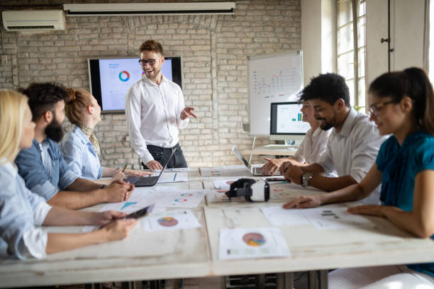 istock Successful happy group of people learning software engineering and business during presentation 1093925890