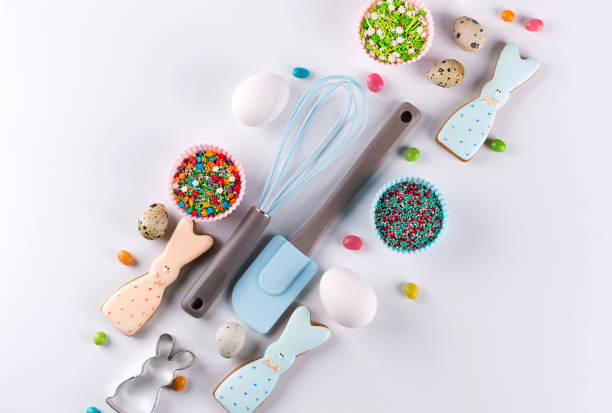 istock Easter spring decorative composition. Making homemade sugar cookies.  Biscuit in the shape of  a  funny  rabbit , tools necessary to make gingerbread pastry, colored sprinkles. 1093926130