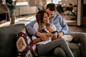 Couple at home watching TV