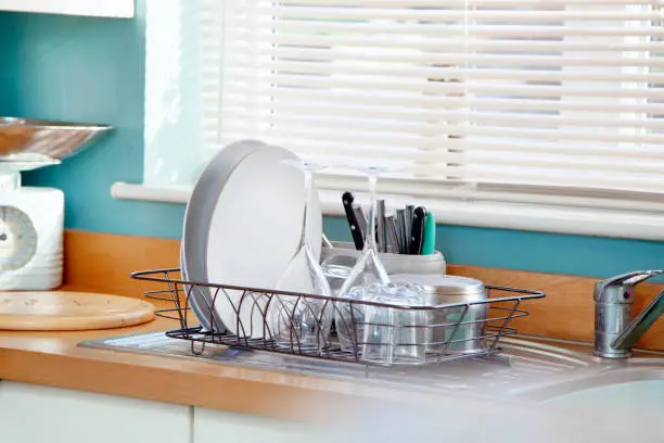 Photo of Kitchen with glasses and plates on a draining board