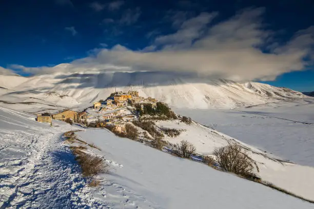 Photo of Wonderful and panoramic view of Castelluccio di Norcia village with snow in the winter season, Umbria, Italy