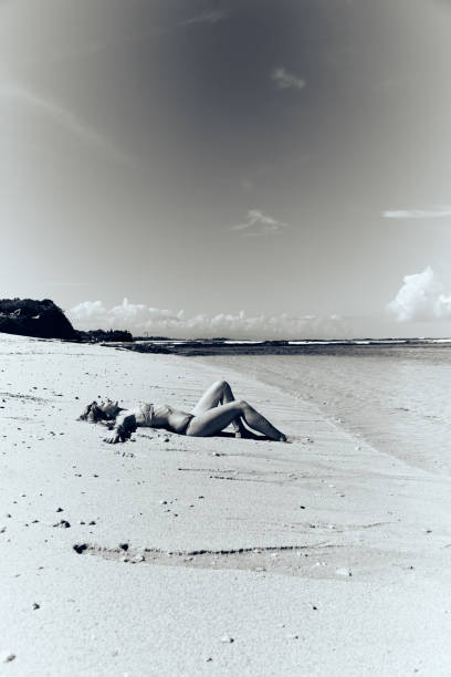 Slim woman enjoying on a sandy tropical beach.