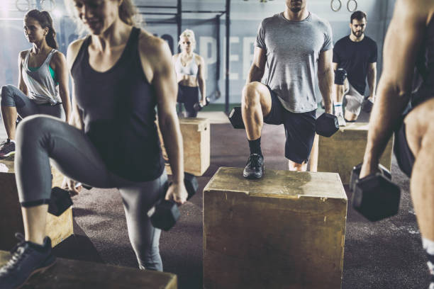 istock Athletic people having cross training with dumbbells in a gym. 1093932832