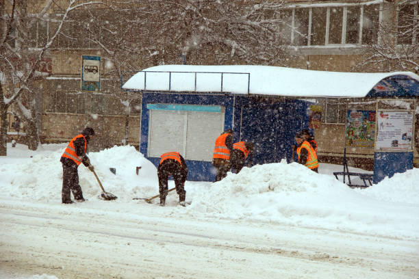 istock Workers clean the bus stop from snow during heavy snowfall in the city 1093932844