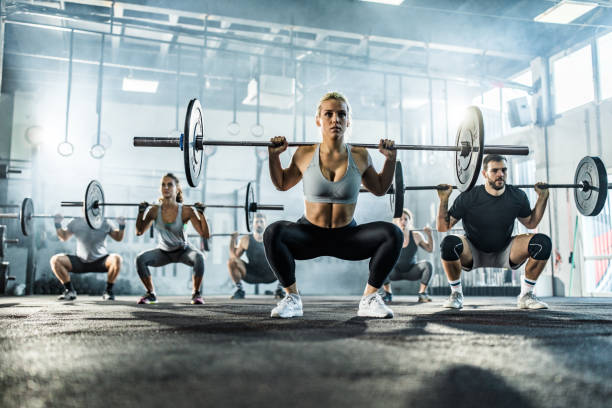 istock Large group of athletes having weight training in a gym. 1093934902