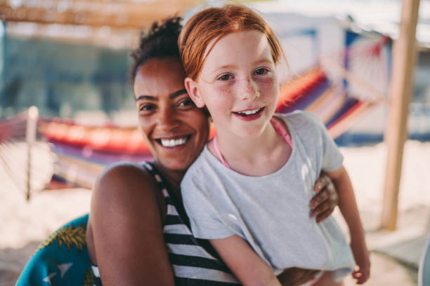 istock Mixed race girls on beach holiday 1093935038