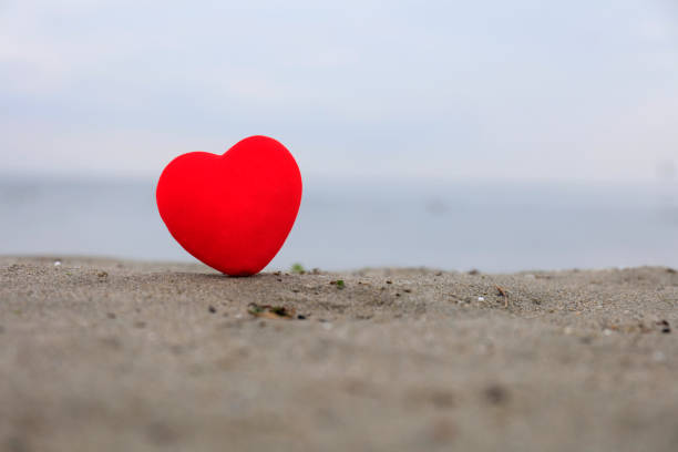 istock Red heart on the beach 1093937550