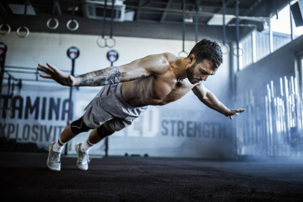 istock Muscular build athlete having training in a gym. 1093937694