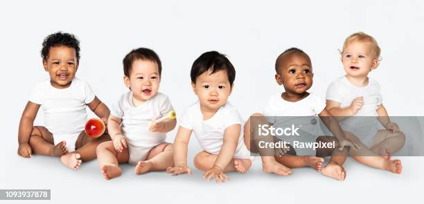Diverse Babies Sitting On The Floor Stock Photo - Download Image Now - Baby - Human Age, Babies Only, Multiracial Group