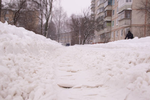 istock Trails from the car tread on the road during heavy snowfall 1093940208