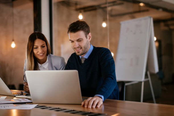 istock Young colleagues sitting together and working in the office 1093941626