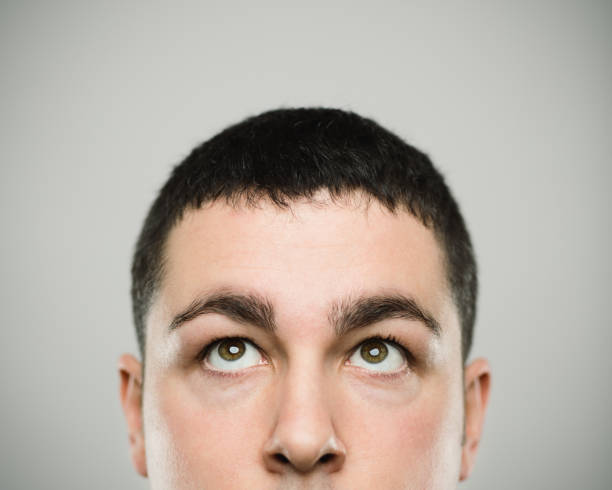 istock Portrait of a real young caucassian man looking up. 1093943284