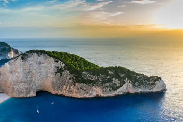 Photo of Greece, Zakynthos, Navagio beach cliffs and endless ocean in magic sunset atmosphere