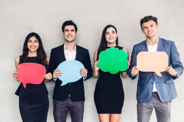 istock Group of business people holding a speech bubble icon 1093944478